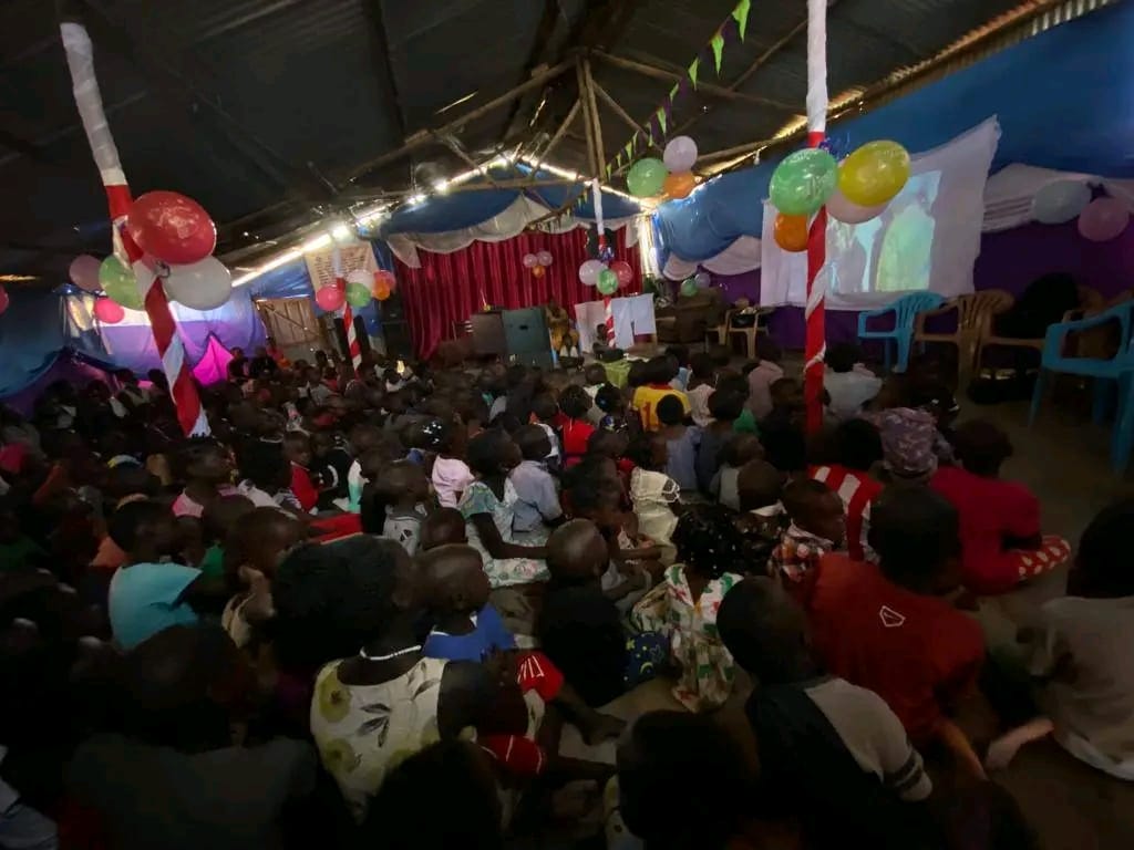 Children watching a film at the Christmas community celebration