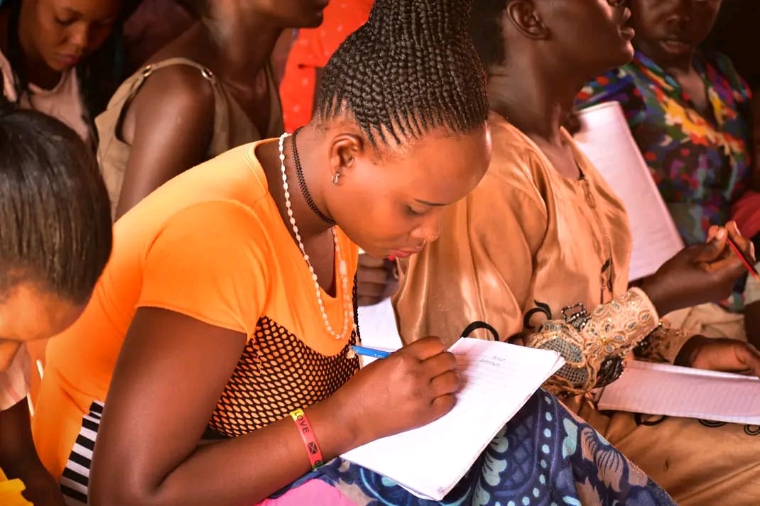 A woman taking notes during a community education class