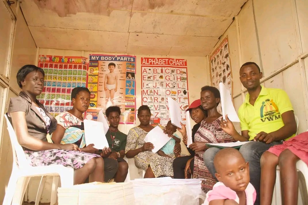 Women gathered for a skills development session with learning charts on the wall