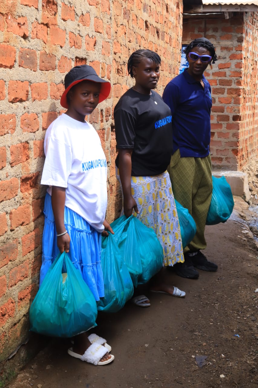 Volunteers distributing food supplies and clothing during the community outreach