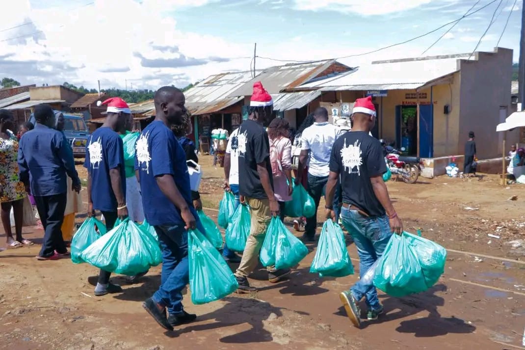 Kuganja Foundation volunteers carrying donation bags through the community